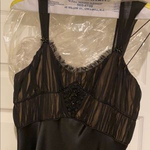 Satin evening gown with touched bust and beading.